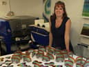 Julie Langan in her workshop at Cedar Farms Galleries, Mawdesley. Julie has raised thousands for Wigan charity The Brick through selling glass rainbows and hearts