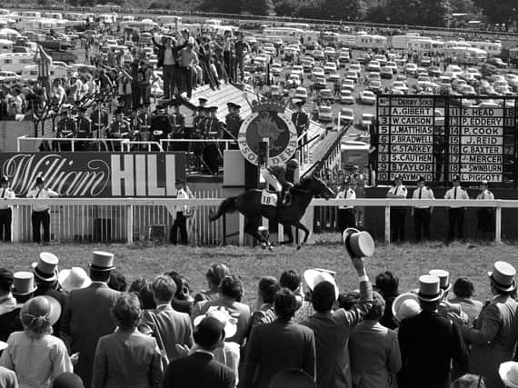 Walter Swinburn takes Shergar past the finishing post at Epsom to win the 202nd, and his first, Derby Stakes