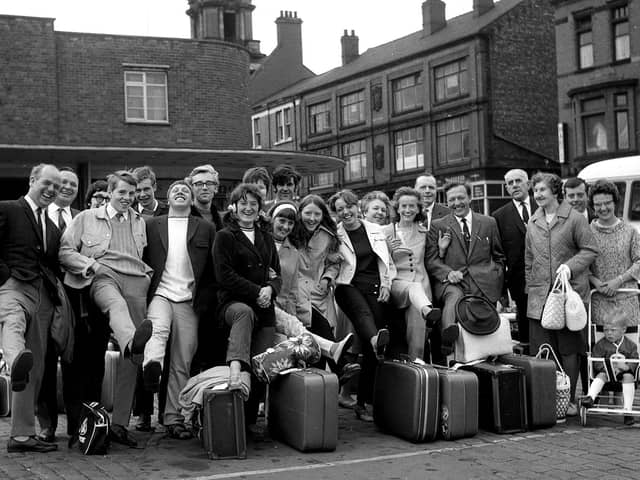 All smiles as Wiganers get ready to board coaches to the seaside during the annual wakes weeks holiday July 1969