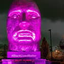 The Face of Wigan lit up purple