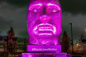 The Face of Wigan lit up purple