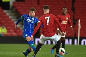 Alfie Devine playing for Latics Under-18s against Manchester United