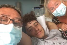 Joshua Whittle in hospital with his parents Jason and Melony