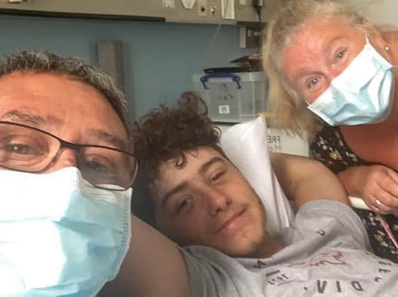 Joshua Whittle in hospital with his parents Jason and Melony