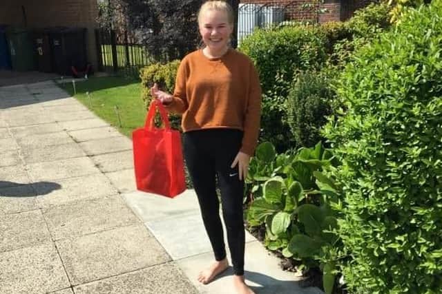 A young Wigan carer gratefully receives a wellbeing pack