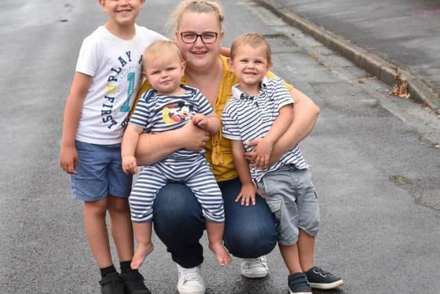 Pictured from left is Lucas Malaki, seven, with little brother Isaac, one, mum Samantha Denton and brother Oscar, two