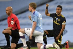 Players and officials take the knee ahead of Manchester City's Premier League clash with Arsenal in midweek
