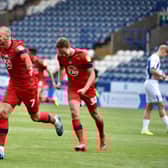 Anthony Pilkington wheels away after putting Wigan 2-0 to the good
(Photos: Bernard Platt)