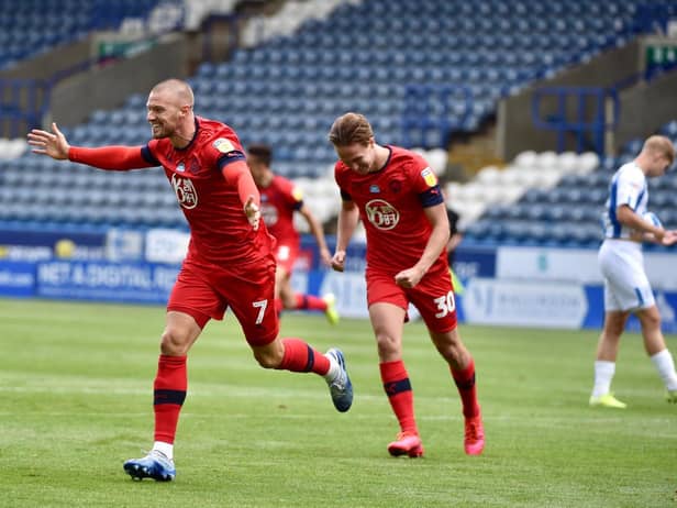 Anthony Pilkington wheels away after putting Wigan 2-0 to the good
(Photos: Bernard Platt)