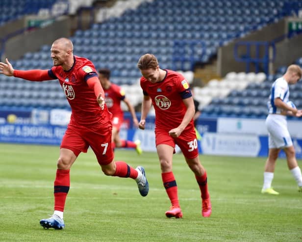 Anthony Pilkington wheels away after putting Wigan 2-0 to the good
(Photos: Bernard Platt)