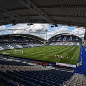 Wigan Athletic and Huddersfield Town warm-up in an empty John Smith's Stadium ahead of kick-off