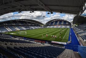 Wigan Athletic and Huddersfield Town warm-up in an empty John Smith's Stadium ahead of kick-off