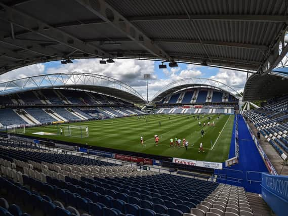 Wigan Athletic and Huddersfield Town warm-up in an empty John Smith's Stadium ahead of kick-off