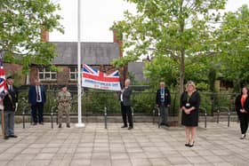 The Armed Forces Day flag is raised in Believe Square