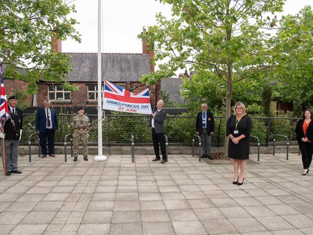 The Armed Forces Day flag is raised in Believe Square