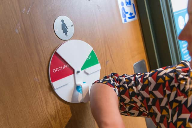 A woman using the facilities at a Greene King pub