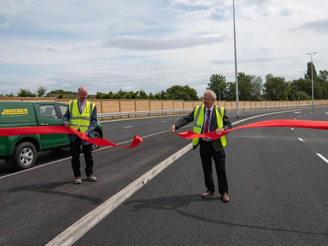 Jones Bros managing director John Dielhof (left) and Leader of Wigan Council, Coun David Molyneux perform the A49 link road opening
