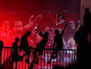 Liverpool fans celebrating outside Anfield, Liverpool, after the club won the Premier League.
