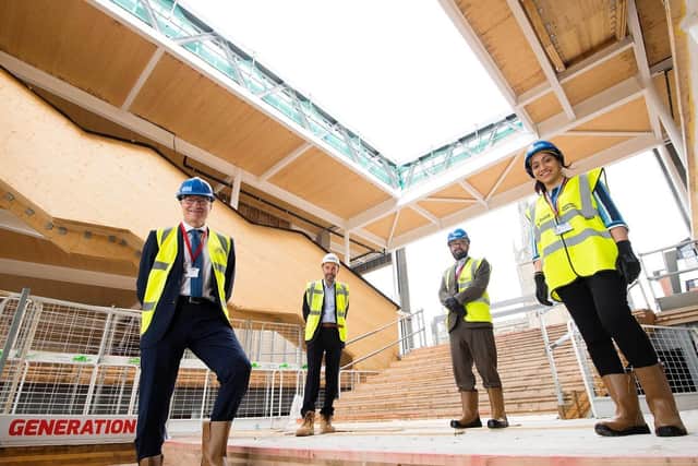 Professor Graham Baldwin celebrates the topping out ceremony with UCLan  and construction company staff.