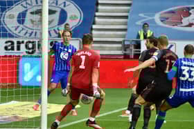 Kieran Dowell's shot deflects off Jack Butland for Wigan's opening goal