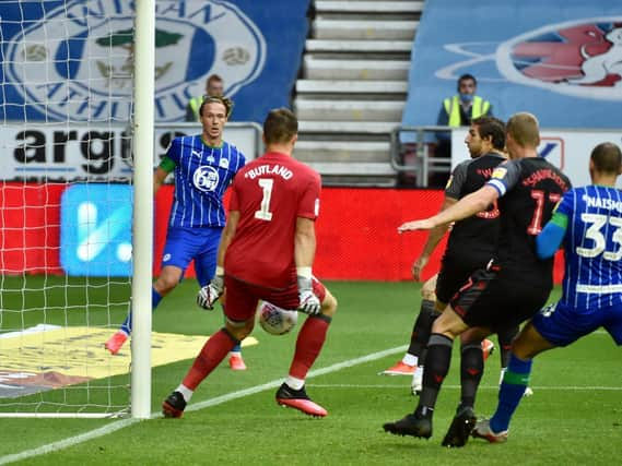 Kieran Dowell's shot deflects off Jack Butland for Wigan's opening goal