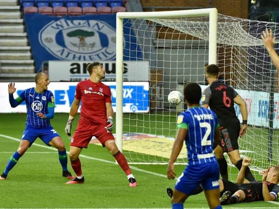 Kal Naismith stabs home his first and Wigan's second goal against Stoke