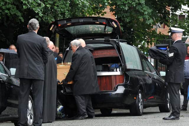 The coffin was carried into the church grounds