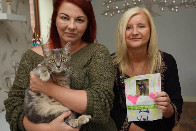 Cat owners, from left, Amanda Thain with her cat Misty and Diane McQuillan holding a photo of her cat Izzy, are delighted to have their pets back after a spate of cat thefts in the Whelley area.  They fear someone is trapping cats and relocating them in the Haigh area