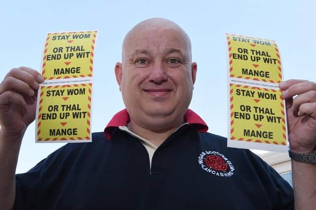 Darren Wood with his light-hearted car stickers bearing a safety message about the coronavirus in Wigan dialect