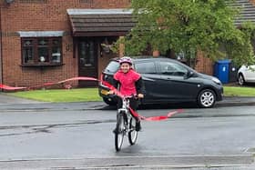 Emily Wyper crossing the finish line of her challenge for Chester Zoo