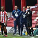 Brentford manager Thomas Frank, right, and Wigan counterpart Paul Cook