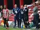 Brentford manager Thomas Frank, right, and Wigan counterpart Paul Cook