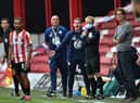 Brentford manager Thomas Frank, right, and Wigan counterpart Paul Cook