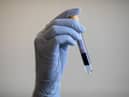 A blood sample is held during a Covid-19 antibody testing program