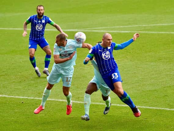 Wigan's Kai Naismithputs his head where it hurts