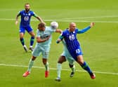 Wigan's Kai Naismithputs his head where it hurts