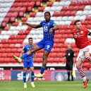 Jamal Lowe rises high to meet the ball ahead of Michael Sollbauer