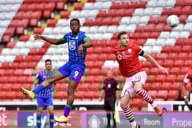 Jamal Lowe rises high to meet the ball ahead of Michael Sollbauer