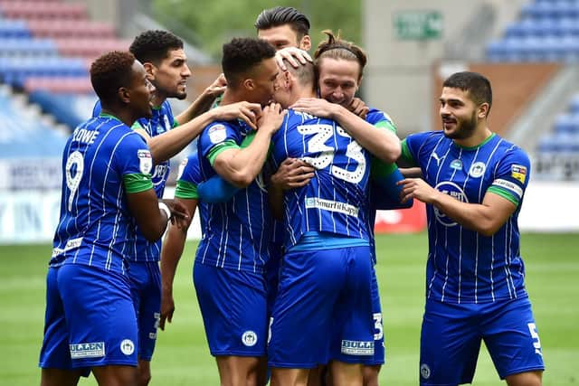 The Latics celebrate an unbelievable 8-0 victory