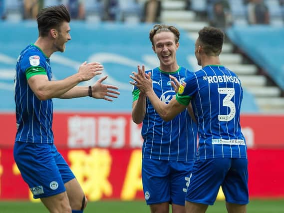 Kieffer Moore, Kieran Dowell and Antonee Robinson celebrate another goal against Hull