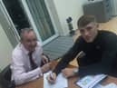 Joe Howarth signs on the dotted line