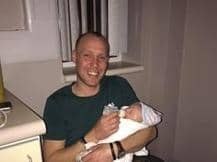 Mark Hill holds his son Corey