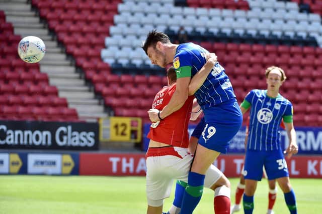 Kieffer Moore heads towards goal, his header was saved but Jamal Lowe was on hand to bundle home the rebound and give the Latics the lead at Charlton