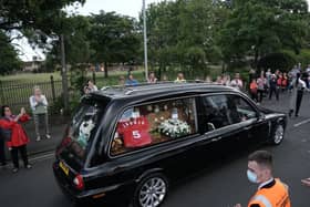 People line the streets as the funeral cortege of Jack Charlton passes through his hometown of Ashington, in Northumberland