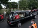 People line the streets as the funeral cortege of Jack Charlton passes through his hometown of Ashington, in Northumberland