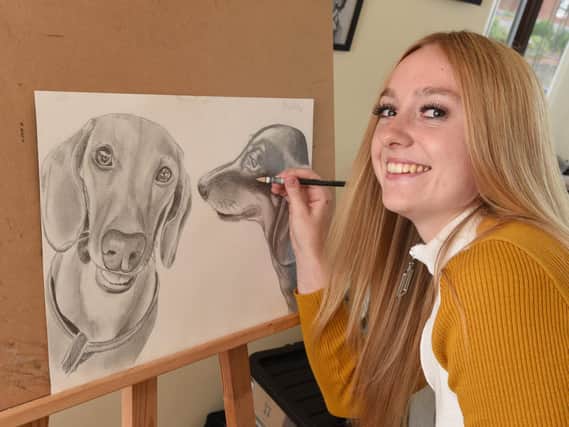 Hannah Walsh at work on one of her portraits