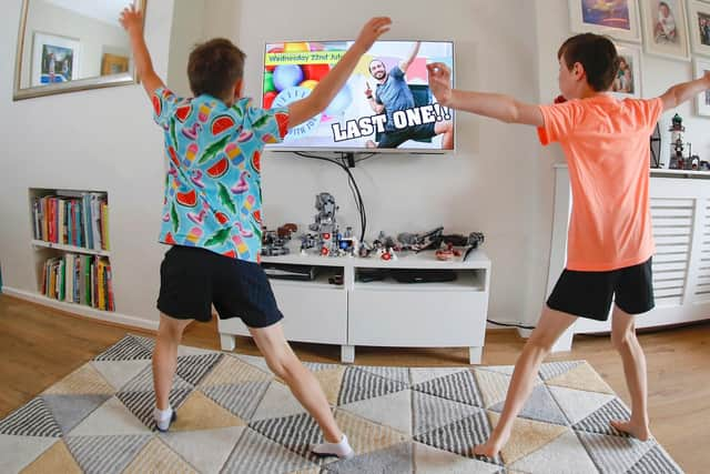 Ben and Isaac Rickett take part in the last session of PE with Joe, the online fitness workout by fitness coach Joe Wicks, at their home