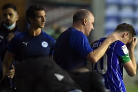 Paul Cook consoles Joe Williams after the final whistle