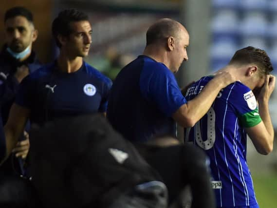 Paul Cook consoles Joe Williams after the final whistle