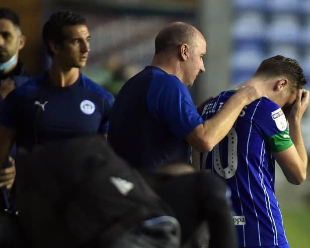 Paul Cook consoles Joe Williams after the final whistle